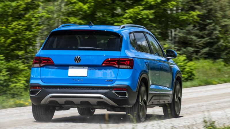 The rear-view photo of the 2024 Volkswagen Taos driving on the road