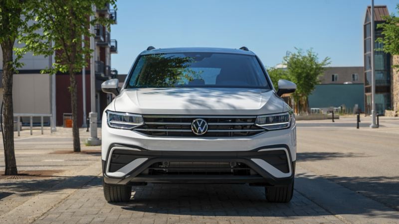 A front-view photo of the white 2024 Volkswagen Tiguan parked on the street