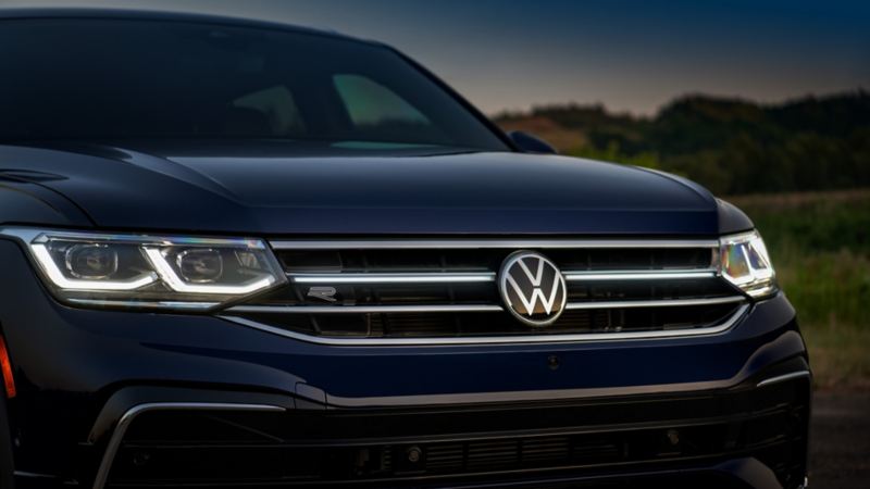 A close-up photo of the 2024 Volkswagen Tiguan featuring Volkswagen sign and front grille