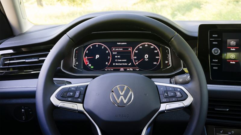 Close-up of the 2025 VW Jetta's steering wheel and digital cockpit, highlighting the vehicle's dashboard and controls.