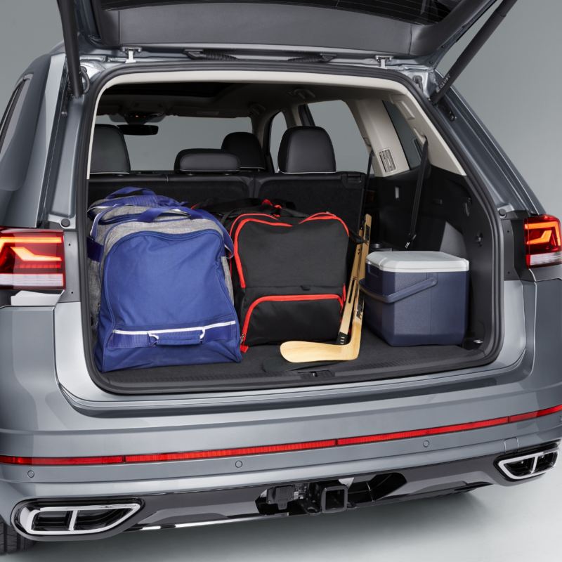 A spacious cargo area of a grey 2025 Atlas, with its rear hatch open, reveals plenty of room for hockey bags.