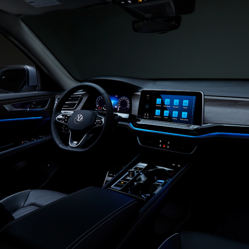 The interior of a 2025 Atlas with modern dashboard, touchscreen display, comfortable seating, and ambient customizable lighting.