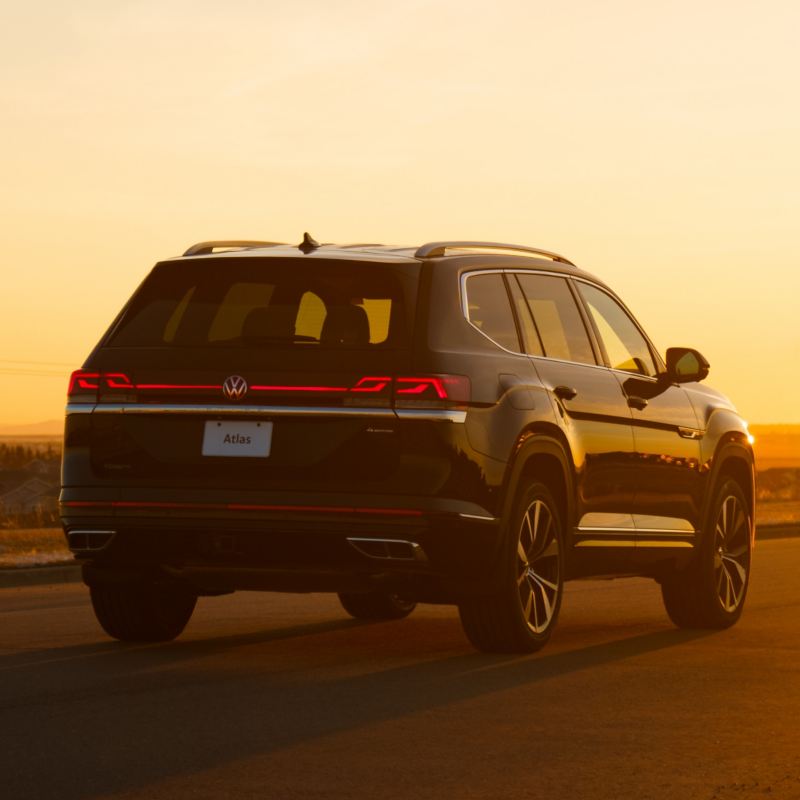 A rear view of a VW Atlas 2025, bathed in the warm glow of sunset.