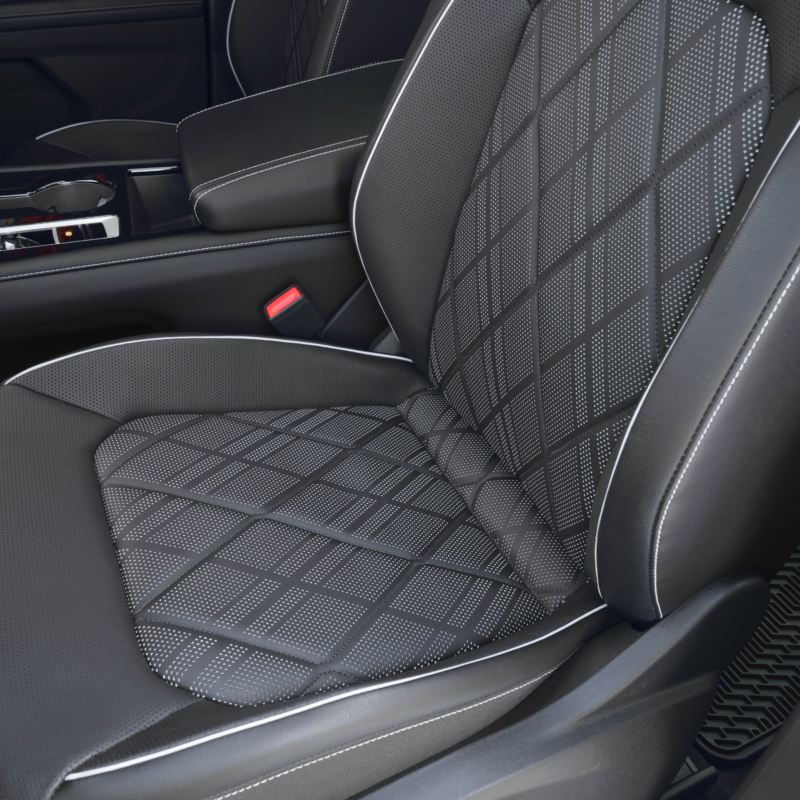 A close-up view of a black leather Atlas 2025 seat with massage function and diamond stitching.