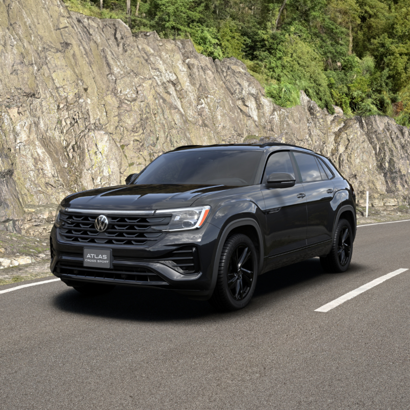 Un élégant SUV VW Atlas Cross Sport R-Line noir se détache sur fond de bâtiment moderne aux fenêtres en verre réfléchissant.