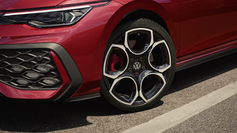 Close-up of a Volkswagen Golf GTI wheel and front fascia.	