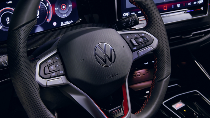 Volkswagen Golf GTI sport steering wheel with physical buttons.