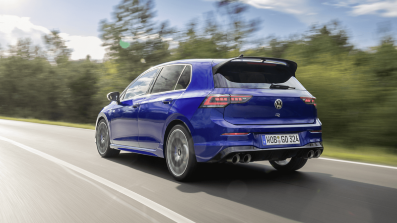 A 2025 blue Volkswagen Golf R, rear view, driving on a highway. 