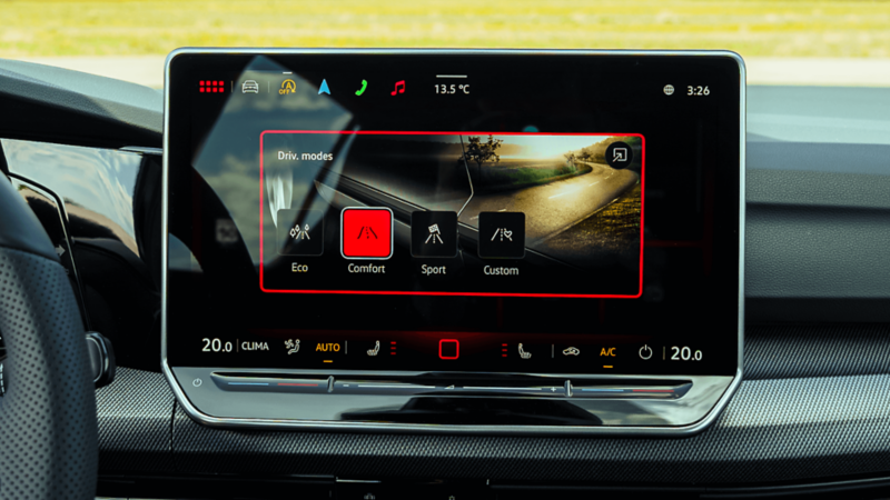 Close-up of 2026 Volkswagen Golf GTI touchscreen showing drive modes: Eco, Comfort, Sport, Custom. 