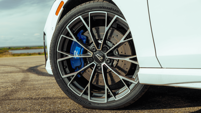 Close-up of the 19" Warmenau forged wheels on a blue Volkswagen Golf R.