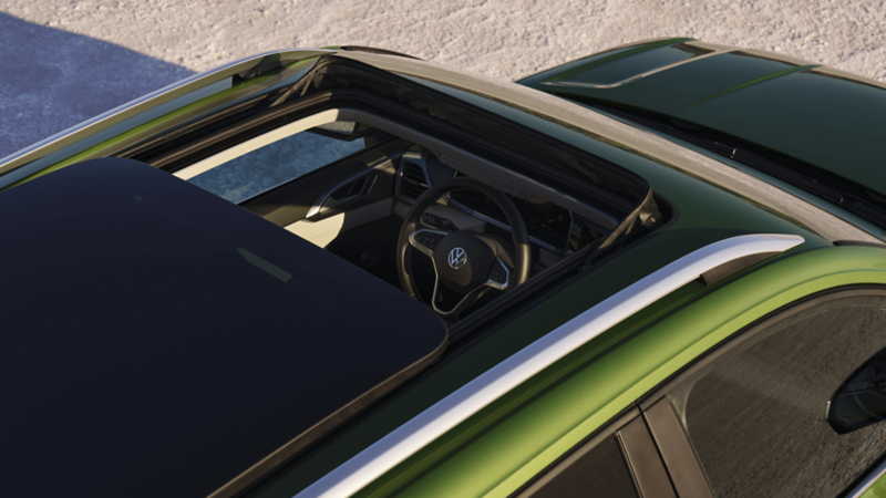 Top view of the 2026 Volkswagen Taos with its panoramic sunroof open, revealing the front seats and steering wheel.