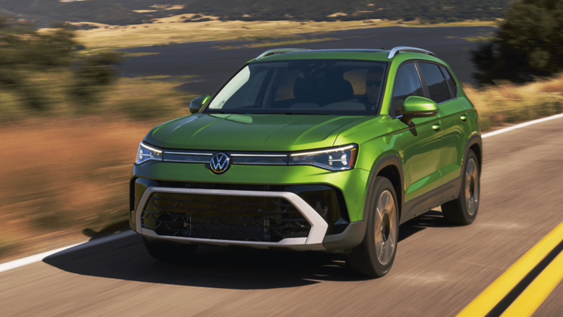 A green 2026 Taos parked on a dirt road