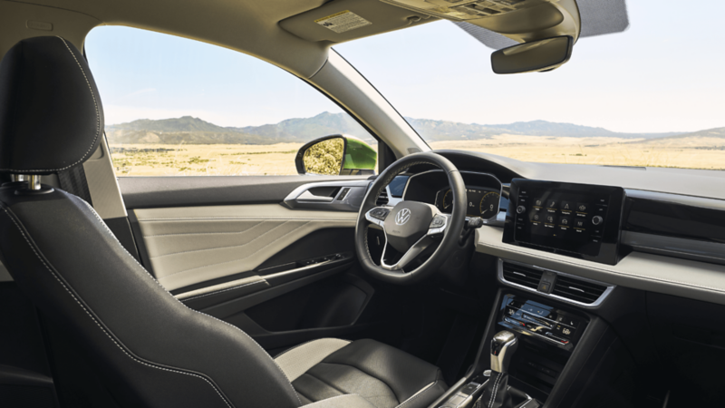Interior shot of the drivers’ seat with mountains in the background