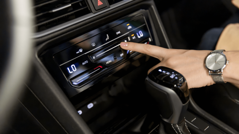 Close-up of the 2026 Volkswagen Taos Climatronic touchscreen climate control panel.