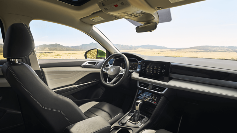 Interior view of the 2026 Volkswagen Taos showing front seats with ventilated and heated features and panoramic sunroof.
