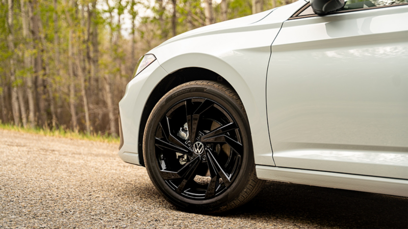 2027 Volkswagen Jetta gloss black alloy wheel with performance brakes on gravel road