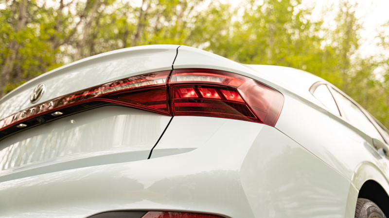 2027 Volkswagen Jetta LED tail light detail with integrated spoiler in Reflex Silver Metallic