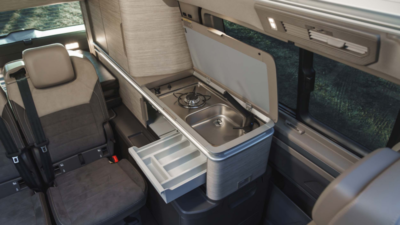 Photo showing the kitchen of a VW California. 