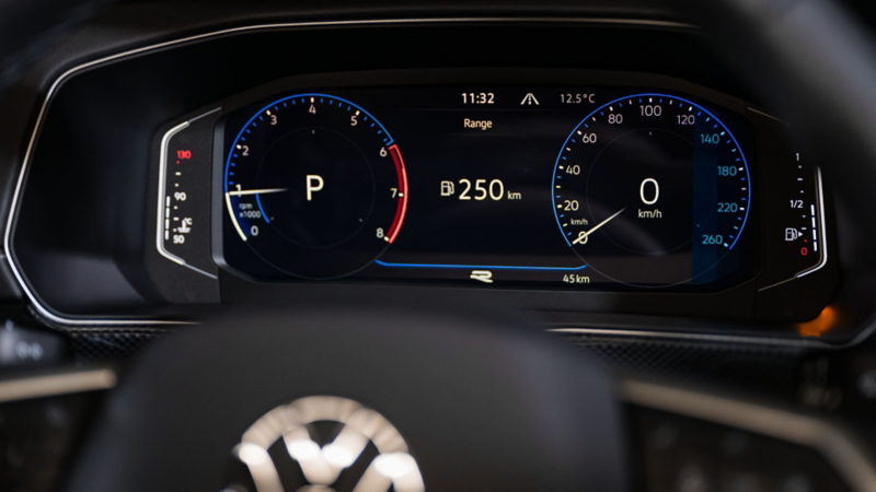 Detailed view of the cockpit of a VW T-Cross behind the steering wheel. 