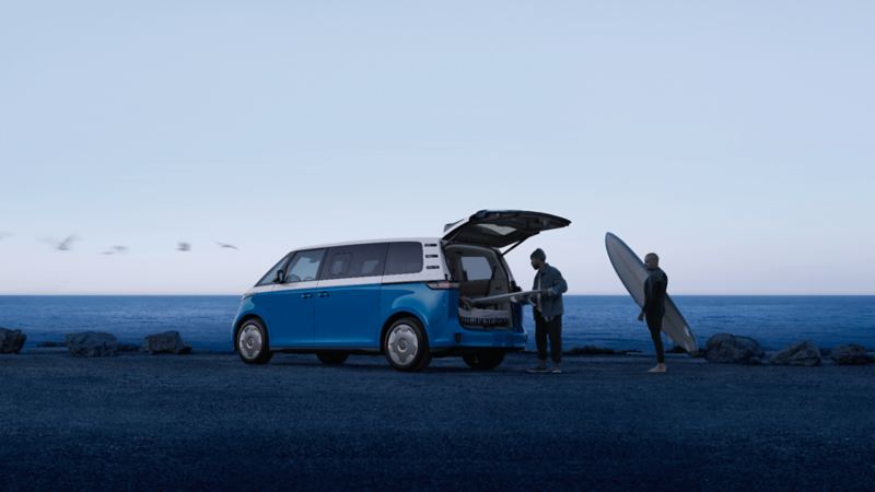 The Volkswagen ID. Buzz 2025 interior with spacious seating, panoramic sunroof, and open sliding doors featuring the "Easy Open" virtual pedal.