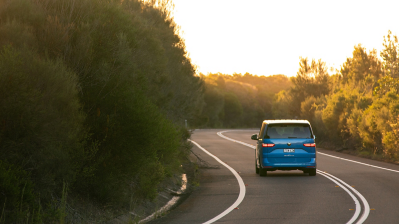 Multivan driving into sunset