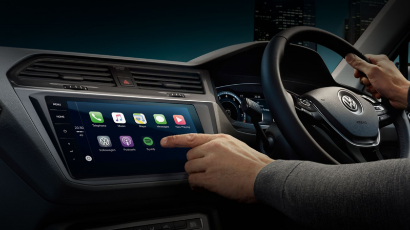 Person using the touchscreen in a VW car