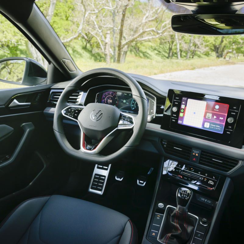 Interior view of the 2025 Jetta GLI showcasing its new interior design with a focus on the dashboard and steering wheel.