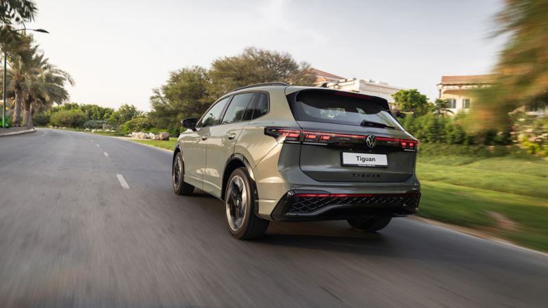 The all-new Tiguan, as viewed from behind, driving down a Dubai road