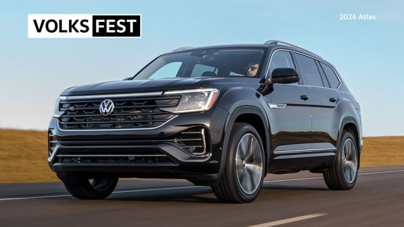 A red Volkswagen Atlas in front of a sunset.