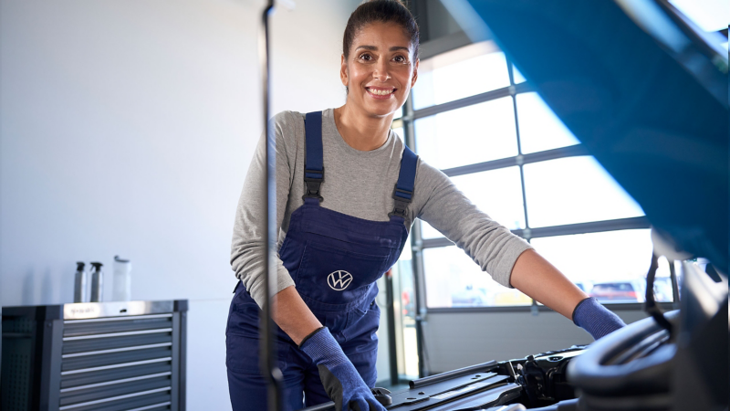 A person servicing a Volkswagen vehicle 