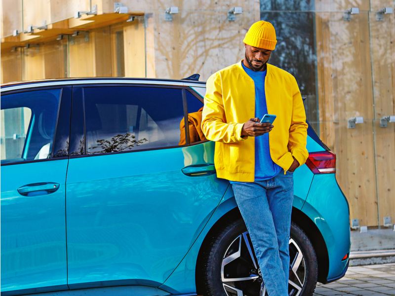 Man in yellow jacket with phone.