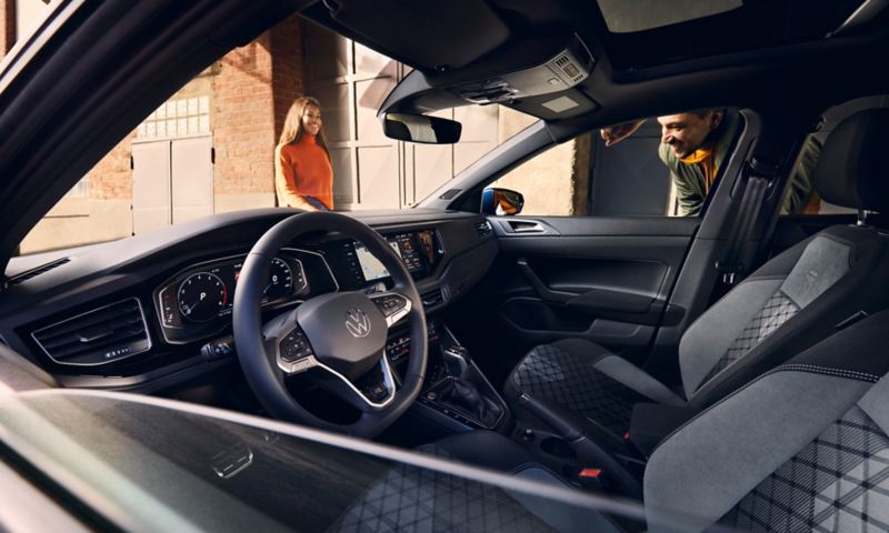 View through the lowered window across the interior of the VW Polo with optional digital cockpit, steering wheel and seats. 