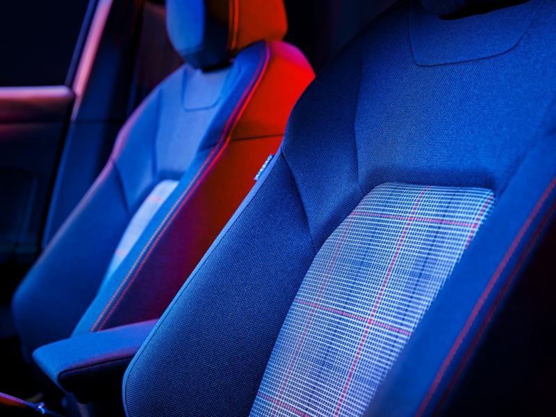 Close-up of the front seats with head restraints in the Polo GTI, the sports seats feature the Scale Paper tartan pattern.