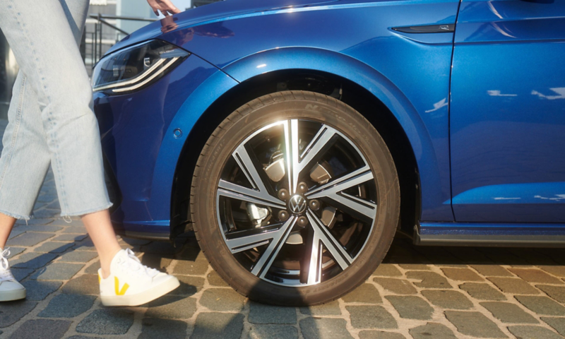 Close up of the wheels on a blue VW Polo