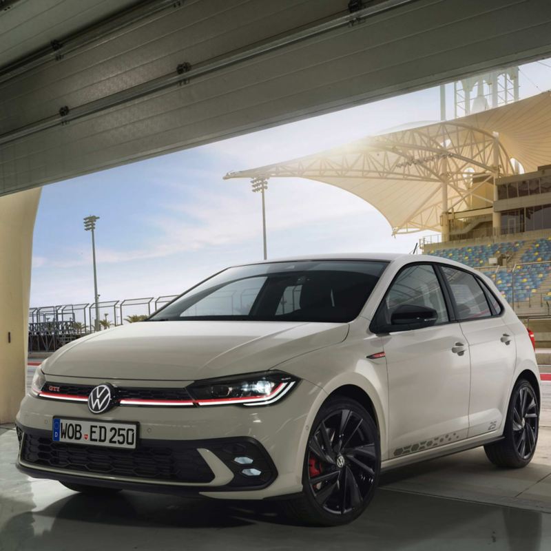 a white POLO GTI driving under a bridge