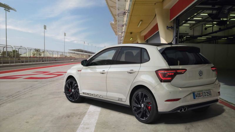 a white POLO GTI driving in a city