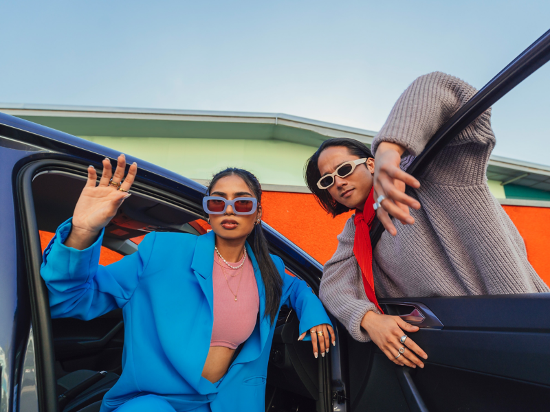 Couples standing near the driver door of the Volkswagen POLO and watching towards camera