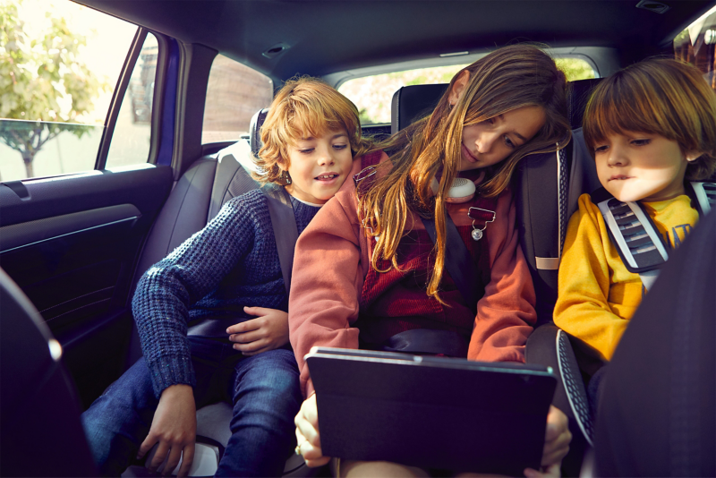 Kids watching Ipad in the backseat of Volkswagen Touareg