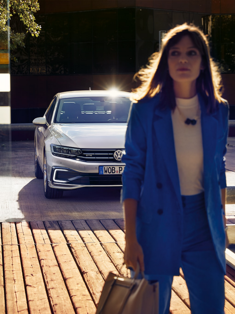 Woman walking in front of a VW Passat