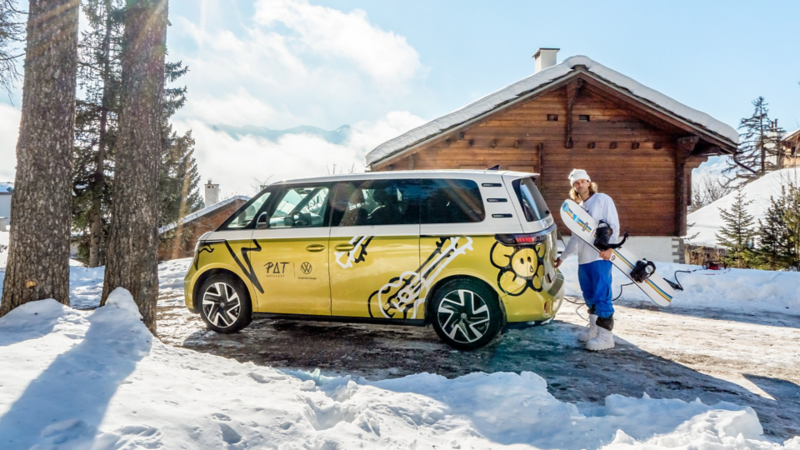 Pat Burgener steht mit seinem Snowboard vor seinem ID.Buzz.
