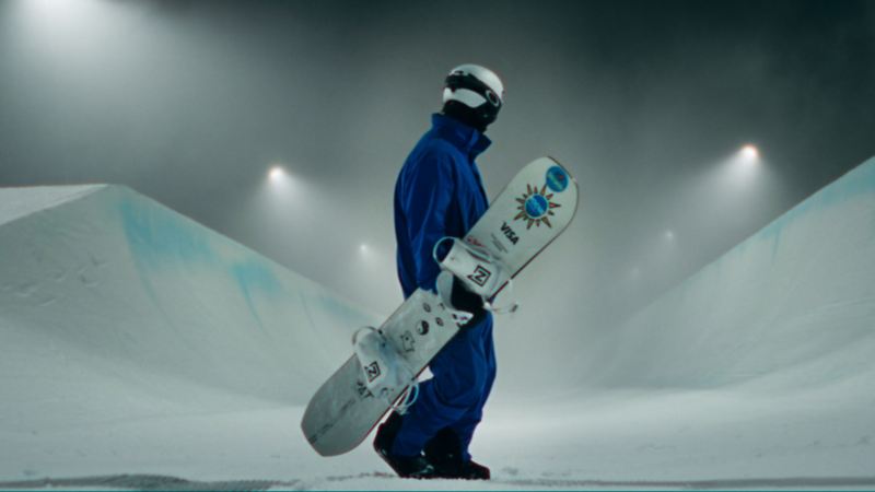 Pat Burgener steht mit seinem Snowboard in einer Schneelandschaft