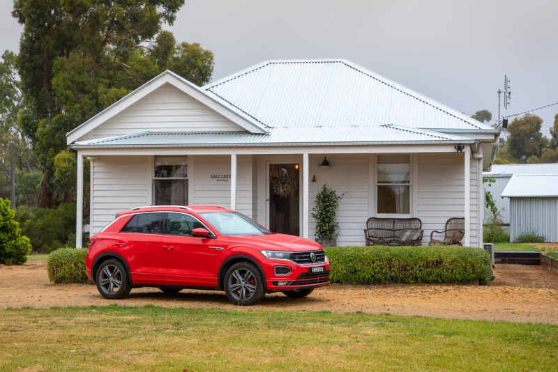 Red VW car parked outside house