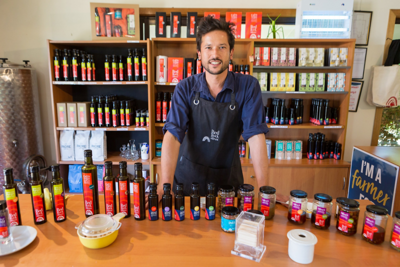Man stood behind counter selling goods