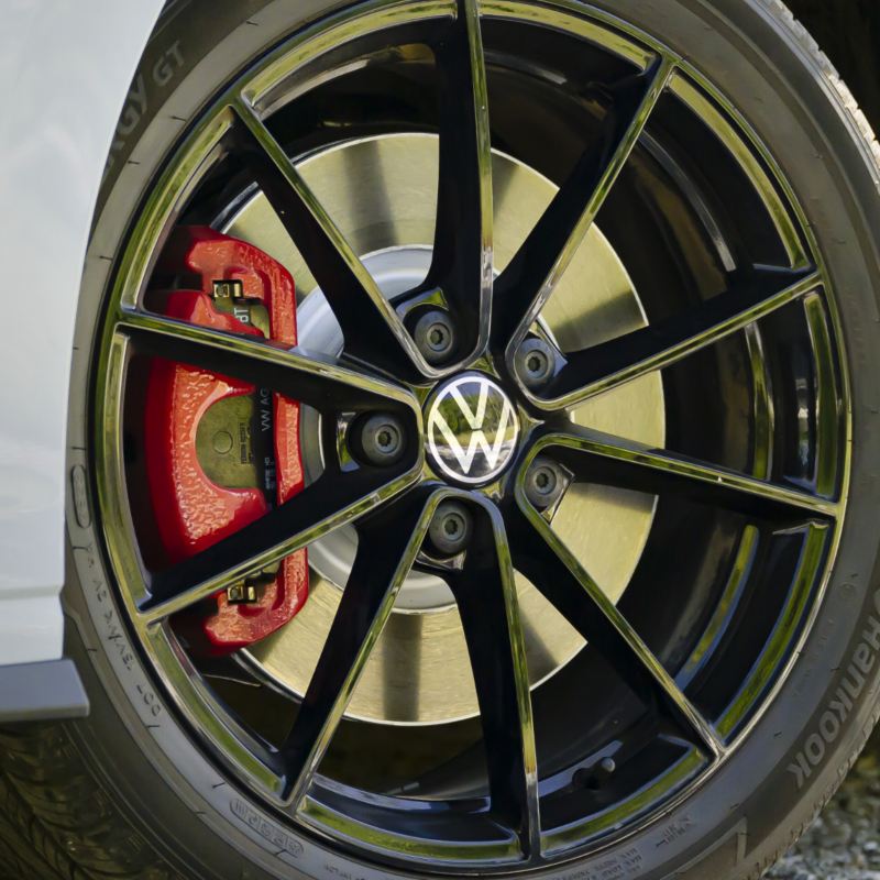 The sporty, multi-spoke black wheels of a 2025 Jetta GLI, close-up.