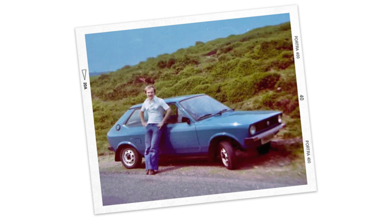 A man leaning against his Polo