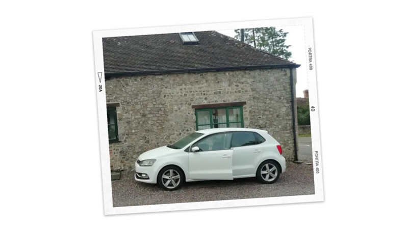 A white Polo parked in front of a building