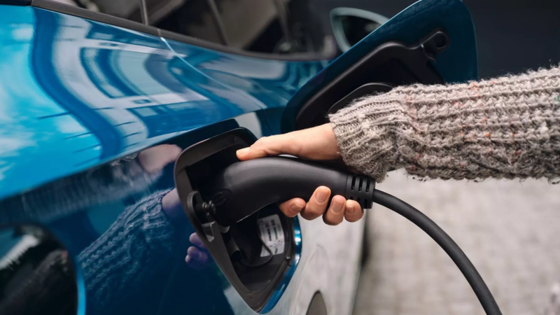 Close up of someone charging a car