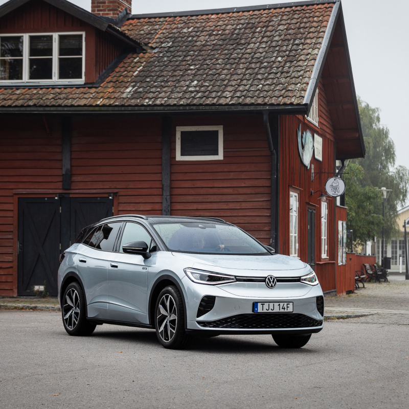 En Volkswagen ID. står parkerad framför ett rött äldre trähus