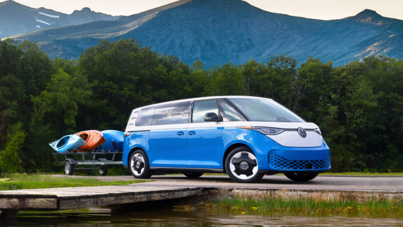 Volkswagen ID. Buzz near a dock with kayaks being towed. 