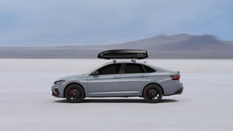 Jetta GLI with a roof rack accessory and a mountain in the background